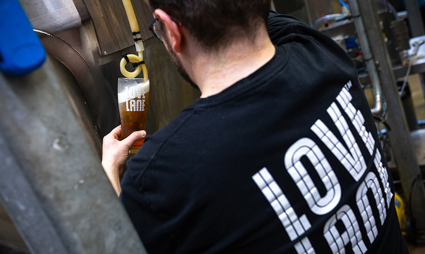 Barman pulling a pint at the Love Lane Brewery